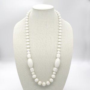 White necklace with acrylic beads and gold seed beads.